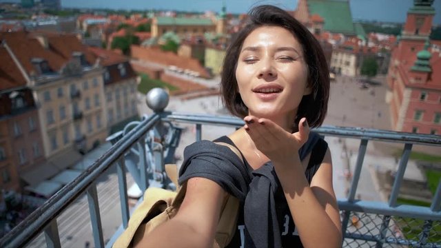 First-person selfie of girl in the city background