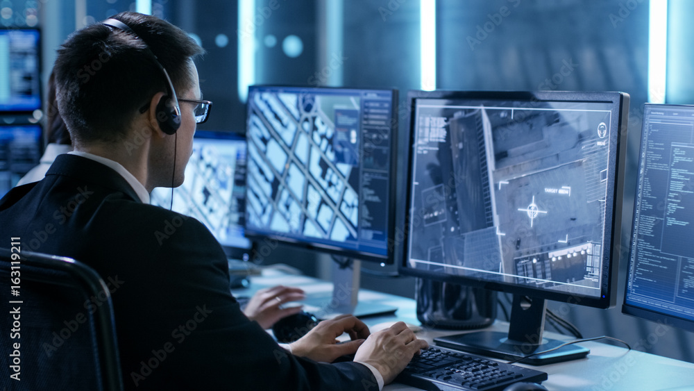 Aufkleber Government Agent is Tracking Fugitive with Her Computer in Big Monitoring Room Full of Computers with Animated Screens.