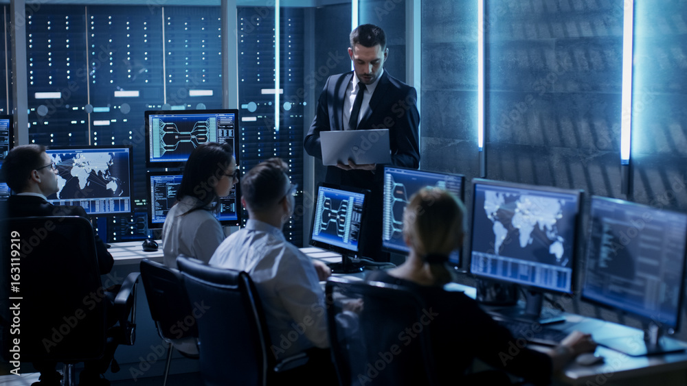 Aufkleber Professional IT Engineers Working in System Control Center Full of Monitors and Servers. Supervisor Holds Laptop and Holds a Briefing. Possibly Government Agency Conducts Investigation.