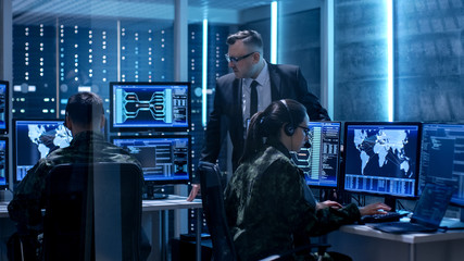 Team of Government Agents Tracking Fugitive with Boss's Survillance in Big Monitoring Room Full of...