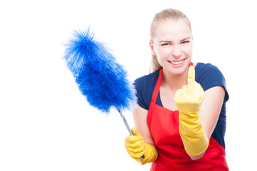 Housewife in cleaning clothes rising middle finger