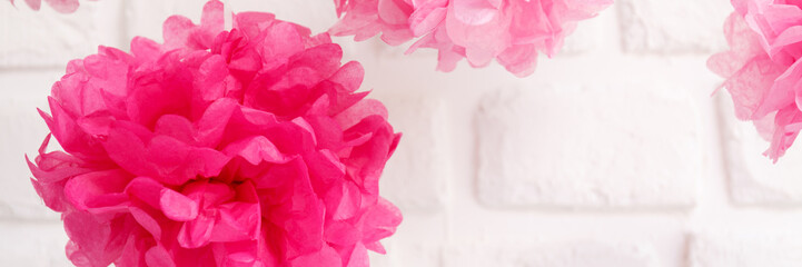 Fototapeta premium Paper flowers at the girl baby shower party. Baby shower celebration concept