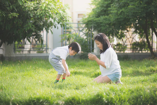 Asian children playing on green grass