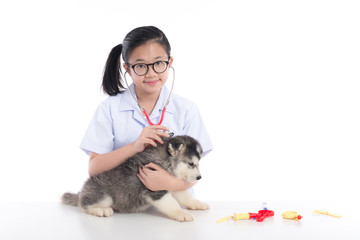 Asian child playing veterinarian