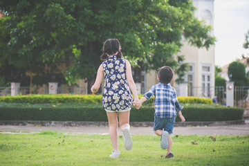 Cute Asian children runing together