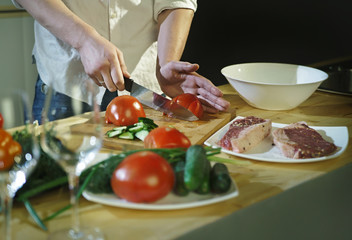 Chef cuts the tomatoes with a knife