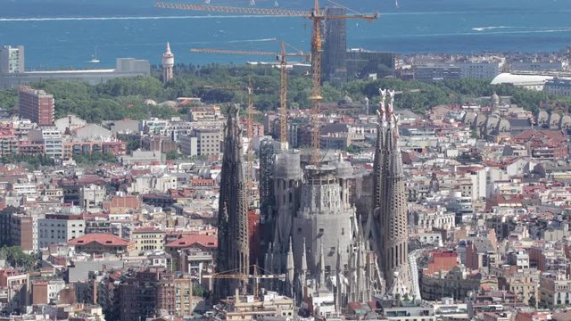 timelapse of barcelona shot from the bunkers de carmel offering amazing panoramic views over the city skyline. this shot focuses in on the sagrada familia cathedral.