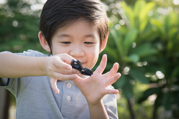 chld  playing  fidget spinner on nature background