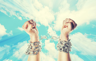 Two hands in chains on a heavens