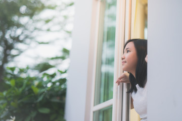 Asian girl look out the window