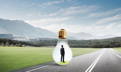 Businessman inside light bulb