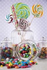 Colorful lollipops and different colored round candy and gum balls