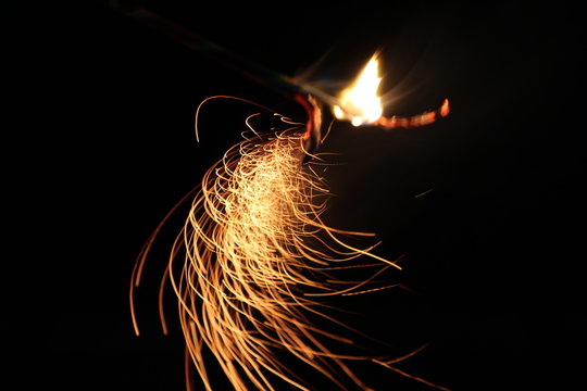 Abstract Texture Background of Fire Sparks With Motion Blur Effect Over Black Background. Slow Shutter