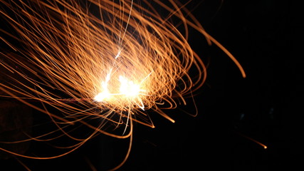 Abstract Texture Background of Fire Sparks With Motion Blur Effect Over Black Background. Slow...