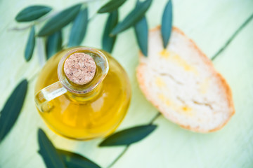 Olive oil in a bottle with olive Leaves and bread