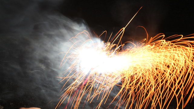 Abstract Texture Background of Fire Sparks With Motion Blur Effect Over Black Background. Slow Shutter