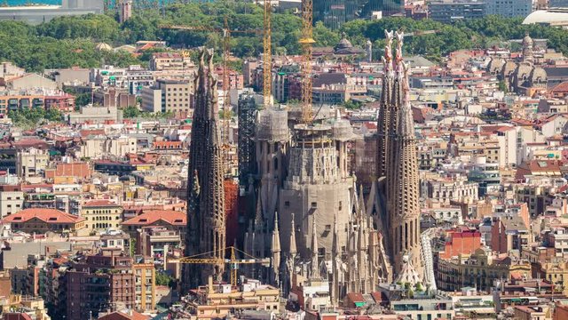 timelapse of barcelona shot from the bunkers de carmel offering amazing panoramic views over the city skyline. this shot focuses in on the sagrada familia cathedral.