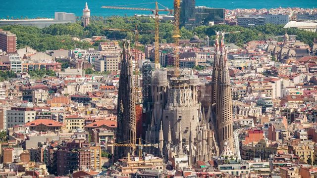 timelapse of barcelona shot from the bunkers de carmel offering amazing panoramic views over the city skyline. this shot focuses in on the sagrada familia cathedral.