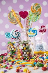 Fototapeta na wymiar Colorful lollipops and different colored round candy and gum balls