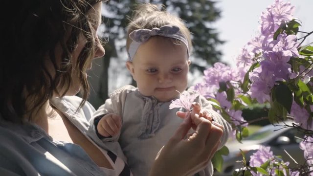 Closeup Slow Motion Shot, Mom Teaches Her Baby Girl How To Smell A Flower