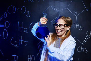 Happy little scientist making experiment
