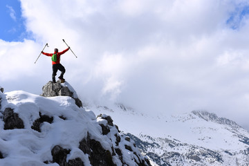 Naklejka na ściany i meble successful climb in the snowy mountains and cloudy