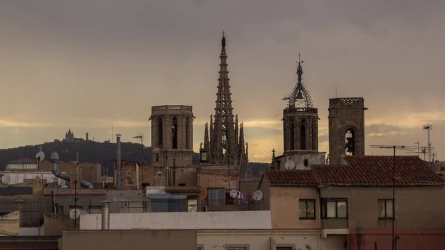 timelapse shot of the rooftops of barcelona shot from a terrace in the centre of the city. the weather this day was a mix of sun and storms creating interesting and beautiful skies