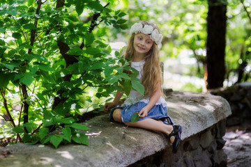 Lovely beautiful girl in the park on a summer day