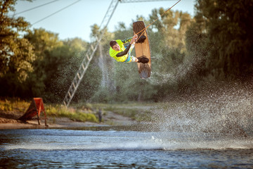 Jumping on a wakeboard on the water, an extreme sport.