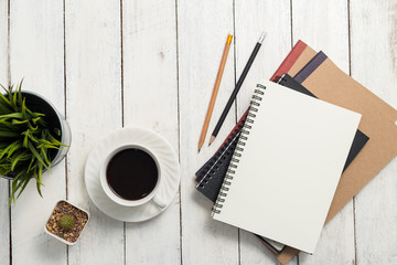 Empty notebook and coffee on  wooden table - obrazy, fototapety, plakaty