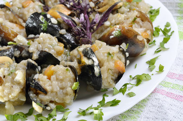 Risotto with mussels  in the plate on a  table/paella/,selective focus