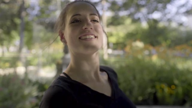 Closeup Of Ballerina Smiling, She Practices Her Spins In Front Of Fountain In Park, Slow Motion