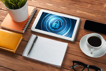 Web security and technology concept with tablet pc on wooden table