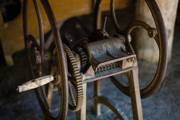 very old spinning wheel and a spindle