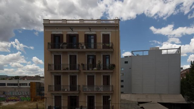 timelapse shot of an apartment building surround by derelict land in the poblenou district of barcelona