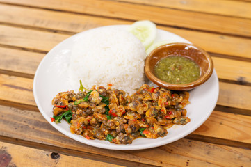 stir fried cockle with basil served with cooked rice.