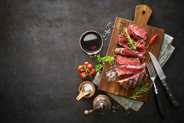 Sliced medium rare grilled beef ribeye steak - obrazy, fototapety, plakaty