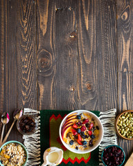 Healthy breakfast with milk,muesli and fruit, on a wooden background.