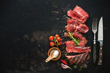 Plexiglas foto achterwand Sliced medium rare grilled beef ribeye steak © Alexander Raths