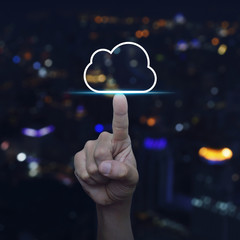 Hand click on cloud icon with copy space over blur colourful night light city tower, Cloud computing concept