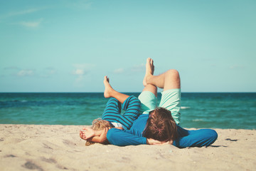 father and son having fun on beach