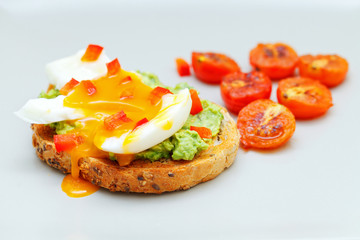 Guacamole toast with eggs and cherry tomato