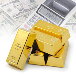 Gold bullion bars stacked on top of each other with financial background