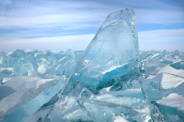 Beautiful transparent blue ice blocks on sky background