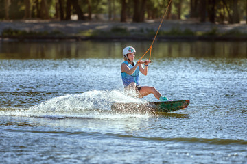 Summer entertainment and sports, water skiing on the board.