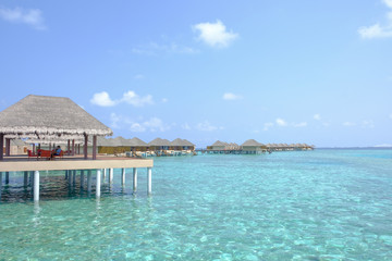 Beautiful dappled water surrounds the colony of water bungalows. Maldives Island.