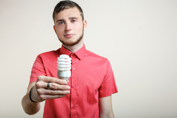 guy is holding a light bulb