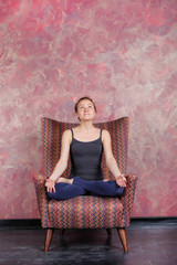 Girl after yoga class. Healthy lifestyle. The girl is practicing meditation in lotus pose....