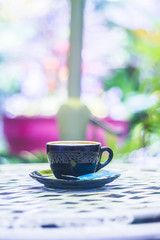 hot of coffee cup on table in cafe Morning light , vintage or retro color tone