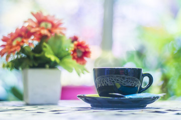 hot of coffee cup on table in cafe Morning light , vintage or retro color tone